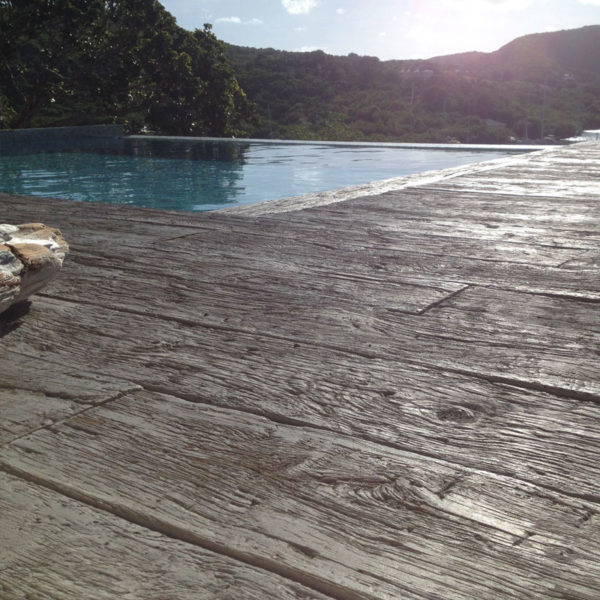 LazyLawn Millboard decking weathered oak driftwood by a pool in Antigua