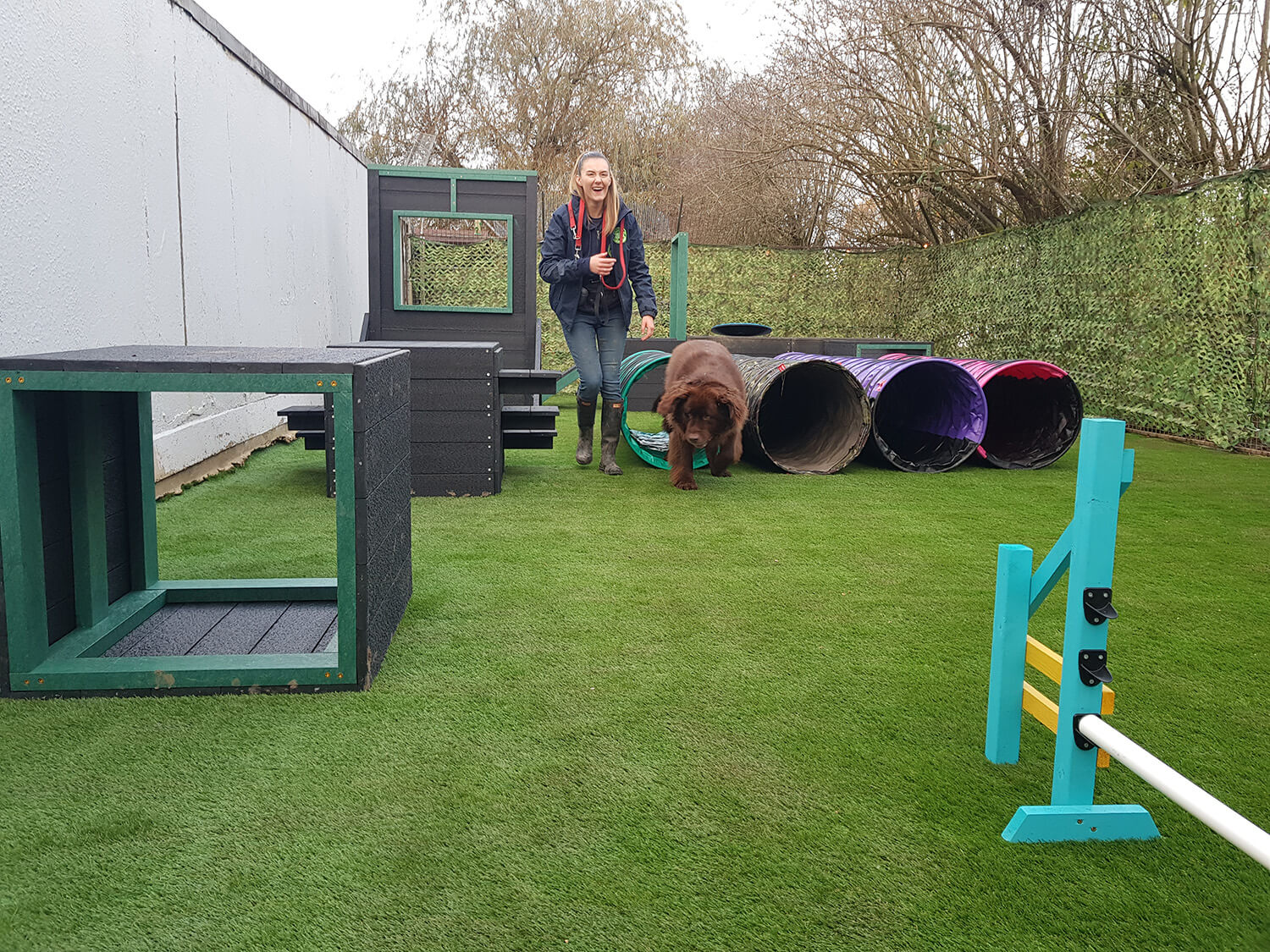 Anneka Rice with a dog on artificial grass