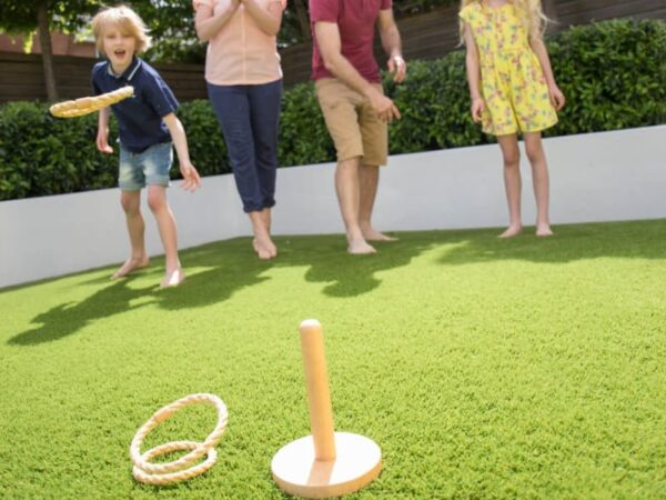 Family playing lawn games on artificial grass